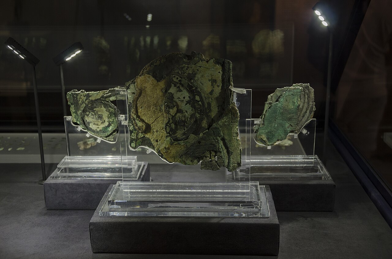 Three corroded fragments of the actual Antikythera mechanism on display in Athens.